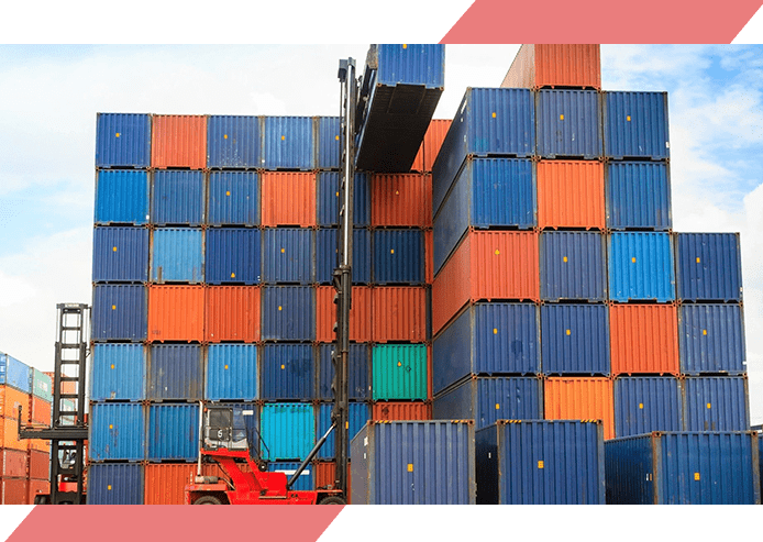 A crane is lifting cargo containers into the air.